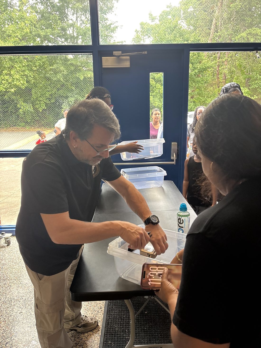 A Tiburo Security officer assisting a visitor at a check-in table