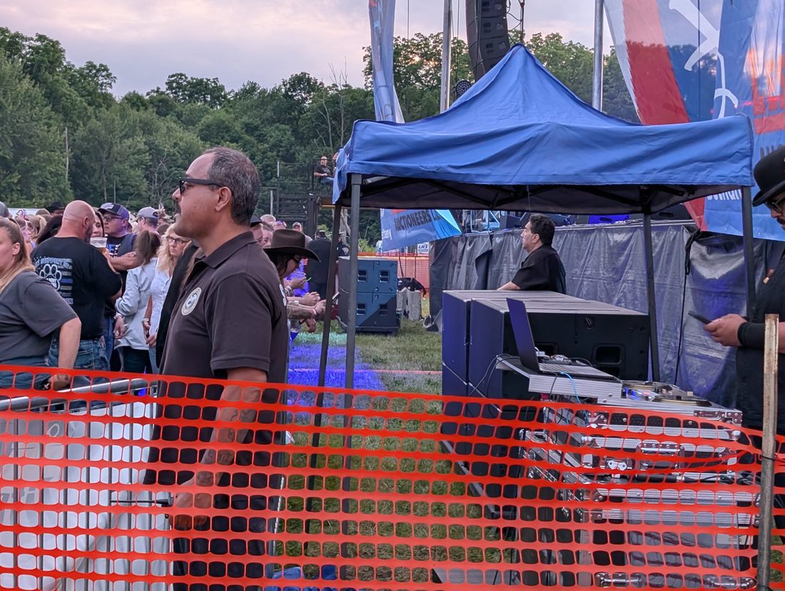 Officer monitoring stage operations at a festival